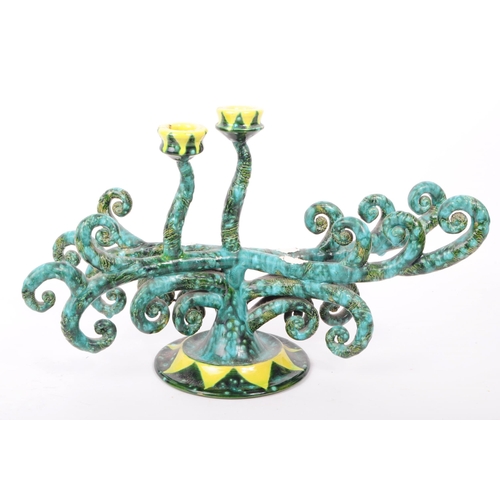 18 - A contemporary studio pottery ceramic candlestick holder, with a maritime design featuring rolled oc... 