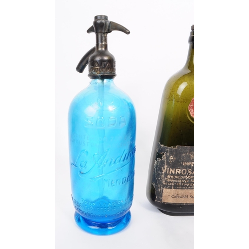 184 - A collection of 20th century soda syphons and point of sale advertisment glass bottles. The collecti... 