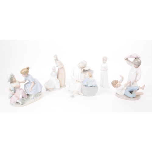 186 - Lladro - Nao - Five late 20th century porcelain figures. Comprised of a mother and a child in a crad... 