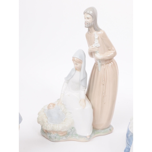 186 - Lladro - Nao - Five late 20th century porcelain figures. Comprised of a mother and a child in a crad... 