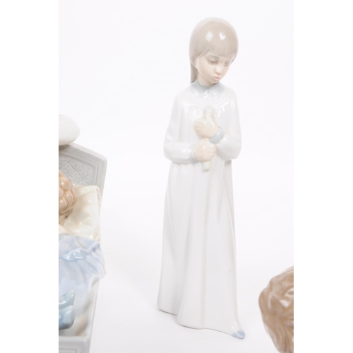 186 - Lladro - Nao - Five late 20th century porcelain figures. Comprised of a mother and a child in a crad... 