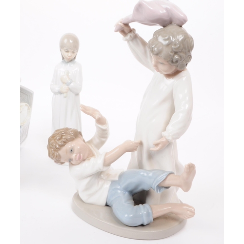 186 - Lladro - Nao - Five late 20th century porcelain figures. Comprised of a mother and a child in a crad... 