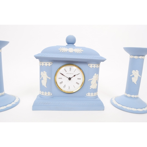 187 - Wedgwood - Vintage late 20th century porcelain mantel clock and candlesticks. Comprised of a Josiah ... 