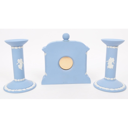 187 - Wedgwood - Vintage late 20th century porcelain mantel clock and candlesticks. Comprised of a Josiah ... 