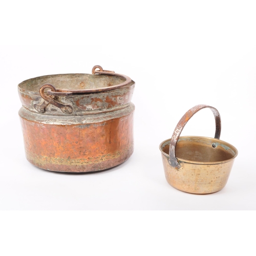 204 - Two early 20th century pans, comprised of a copper swing handled cooking pot / pan, and a brass jam ... 