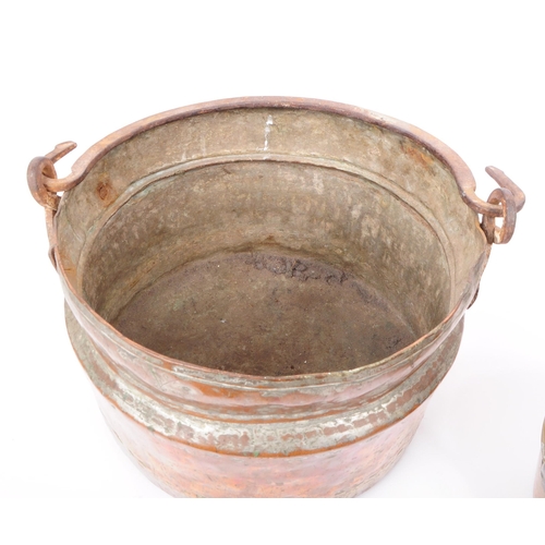 204 - Two early 20th century pans, comprised of a copper swing handled cooking pot / pan, and a brass jam ... 