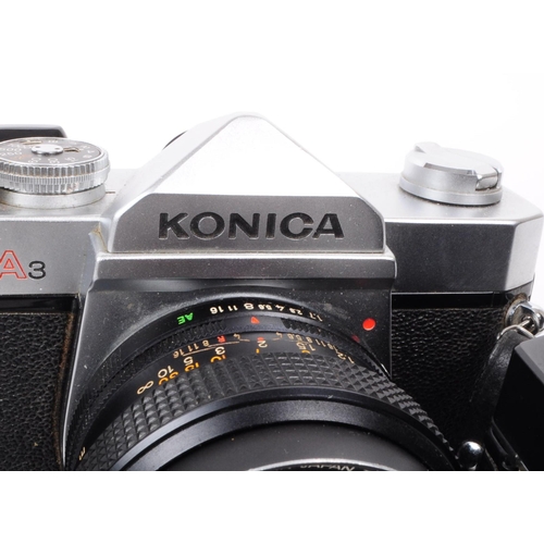 221 - Konica - Two vintage 20th century Konica AutoReflex 35mm SLR cameras with lenses. The collection to ... 