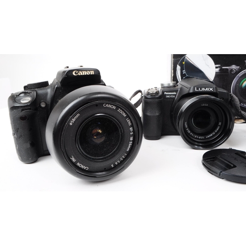 223 - A collection of 21st century digital SLR and bridge cameras. The collection to include two Canon EOS... 