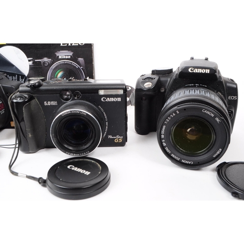 223 - A collection of 21st century digital SLR and bridge cameras. The collection to include two Canon EOS... 