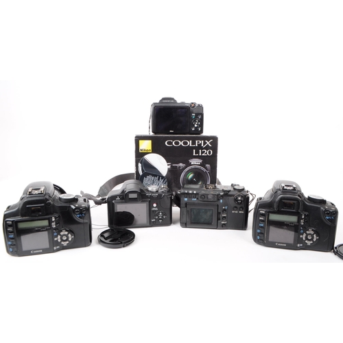 223 - A collection of 21st century digital SLR and bridge cameras. The collection to include two Canon EOS... 