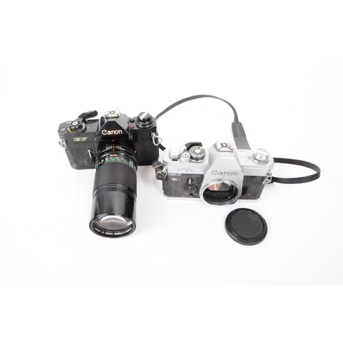 233 - Canon - Two vintage 20th century 1970s Canon 35mm SLR cameras. The collection to include a silver bo... 