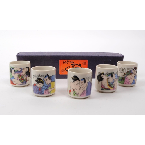 28 - A vintage 20th century Japanese ceramic sake cup set. The set featuring erotic imagery. In original ... 