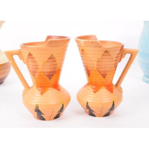 32 - A collection of five art deco style studio pottery vases / jugs, comprised of two Ionia jugs, a Besw... 