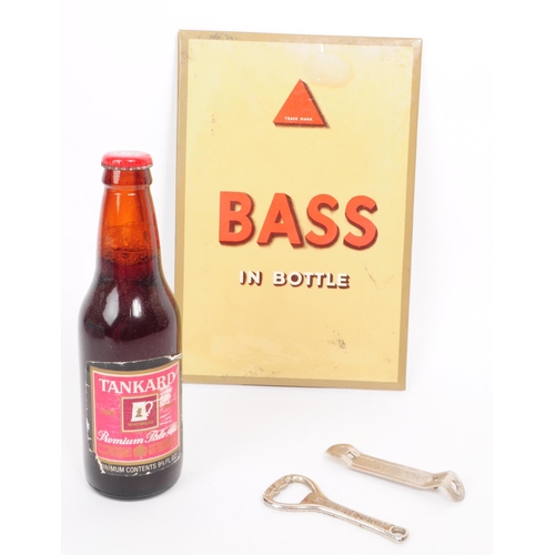 377 - Breweriana. Vintage beer stand-up card advert for “BASS IN A BOTTLE”, a full unopened bottle of Whit... 