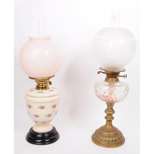 386 - Two 20th century oil lamps, comprised of a dulex brass framed oil lamp with glass chimney, glass res... 