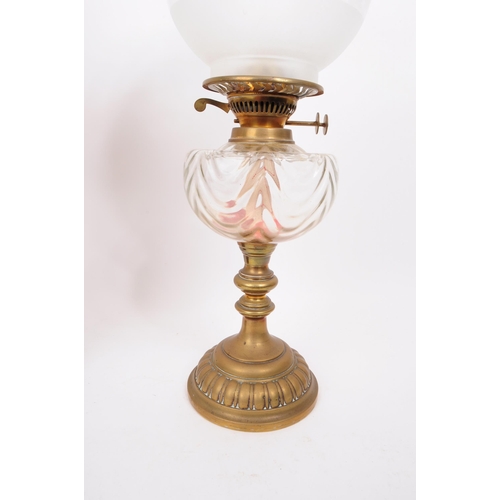 386 - Two 20th century oil lamps, comprised of a dulex brass framed oil lamp with glass chimney, glass res... 