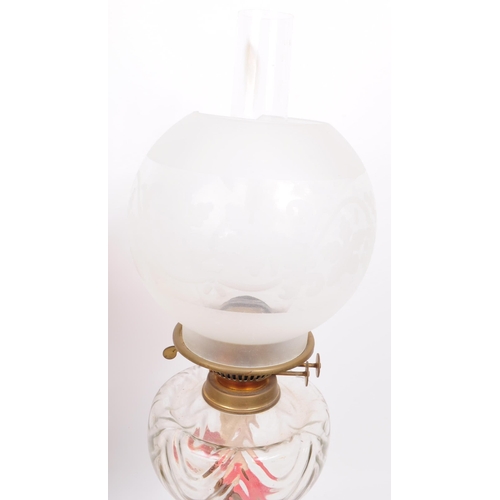 386 - Two 20th century oil lamps, comprised of a dulex brass framed oil lamp with glass chimney, glass res... 