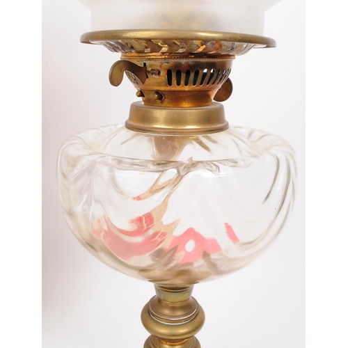 386 - Two 20th century oil lamps, comprised of a dulex brass framed oil lamp with glass chimney, glass res... 