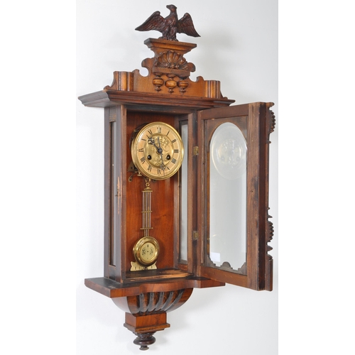 387 - 19th century Victorian mahogany wall clock with a glazed case and carved eagle mount atop. The case ... 