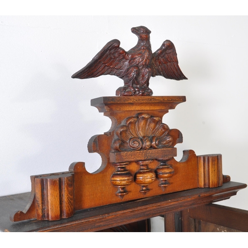 387 - 19th century Victorian mahogany wall clock with a glazed case and carved eagle mount atop. The case ... 