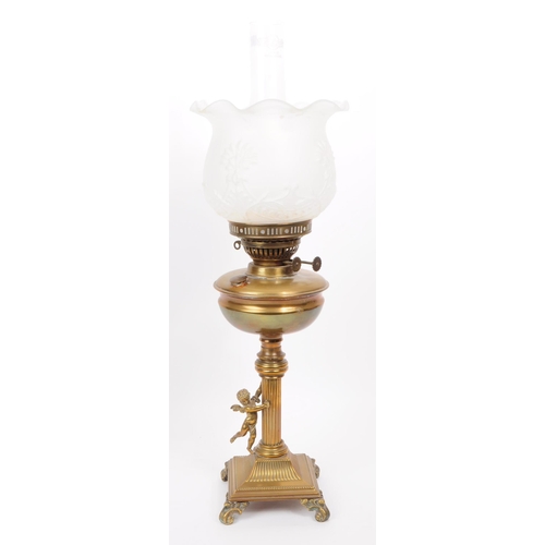 391 - Early 20th century brass columnar oil lamp mounted on four scrolled feat with a brass cherub figure ... 