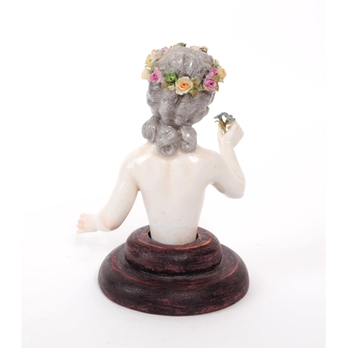 51 - Dressel & Kister - A 1910 Dresden German porcelain half doll figure, depicted holding flowers, m... 