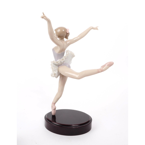 56 - Lladro - A vintage late 20th century ballerina porcelain figurine, the figure in a ballet pose, with... 