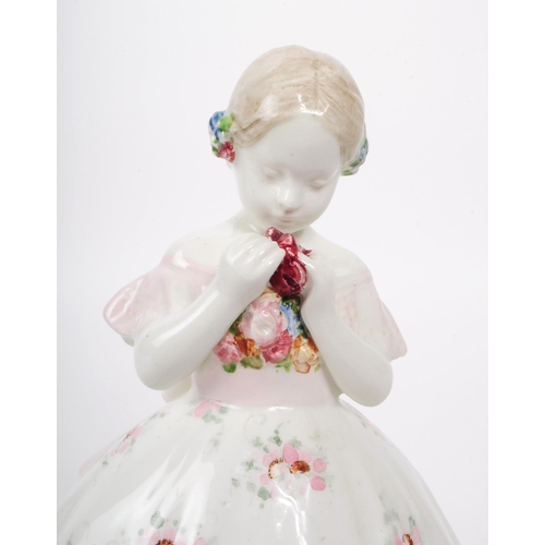 60 - Johann Petrides for Goldscheider - A 1920 art deco porcelain figurine of a girl holding a rose, feat... 