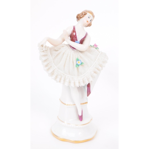 63 - Four vintage 20th century German porcelain dancer figures, in lace dresses and hand painted to the b... 