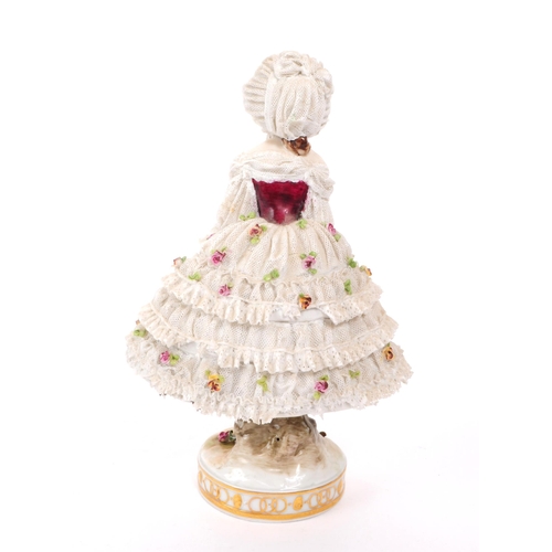 72 - Volkstedt Rudolstadt - An early 20th century porcelain lady figurine.  Featuring a lace dress and bo... 