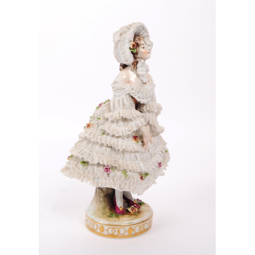 72 - Volkstedt Rudolstadt - An early 20th century porcelain lady figurine.  Featuring a lace dress and bo... 