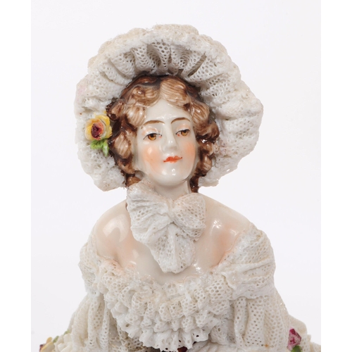 72 - Volkstedt Rudolstadt - An early 20th century porcelain lady figurine.  Featuring a lace dress and bo... 