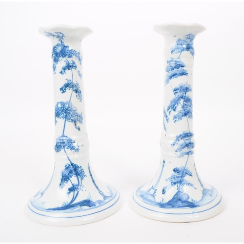 75 - Deborah Sears - Isis Art Pottery - A pair of late 20th century blue and white delft manner candlesti... 