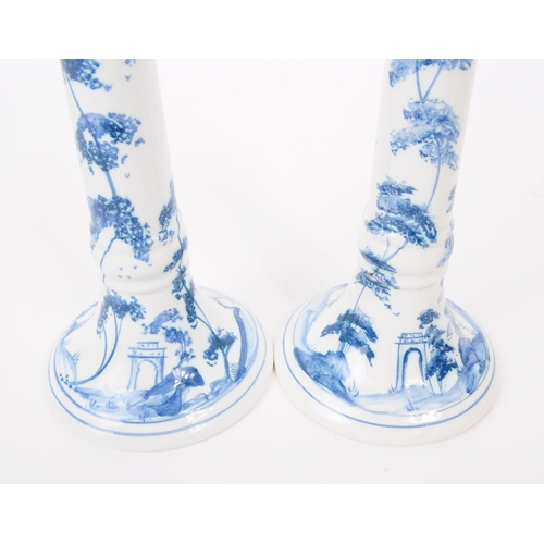 75 - Deborah Sears - Isis Art Pottery - A pair of late 20th century blue and white delft manner candlesti... 