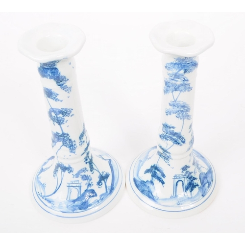 75 - Deborah Sears - Isis Art Pottery - A pair of late 20th century blue and white delft manner candlesti... 