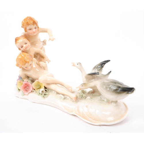 78 - Karl ENS - Volkstedt - Two early 20th century German porcelain figures. One depicting three cherubs ... 