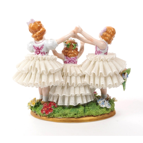 81 - Sitzendorf - 20th century German porcelain children figurine. Featuring three children in lace dress... 