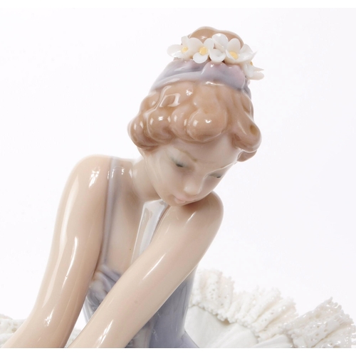 82 - Lladro - Two late 20th century porcelain Ballerina lady figures, comprised of a sitting Ballerina no... 