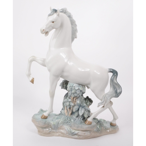 84 - Lladro - Late 20th century porcelain Caballo Arrogante horse / stallion figure. Depicting a white ho... 