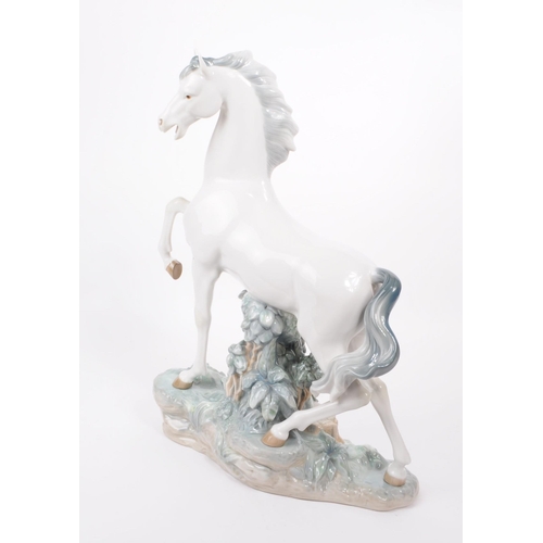 84 - Lladro - Late 20th century porcelain Caballo Arrogante horse / stallion figure. Depicting a white ho... 