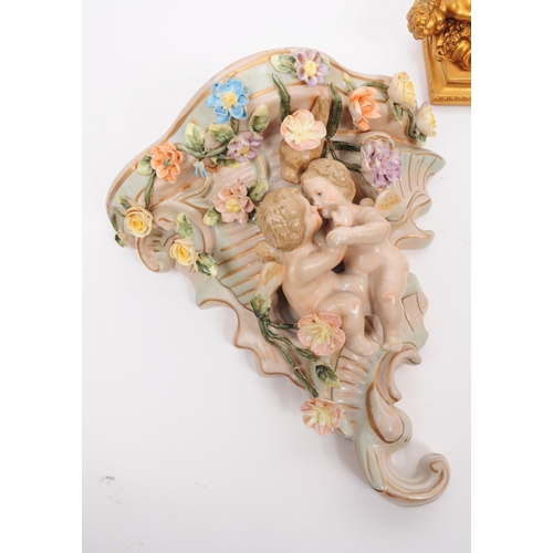 86 - Two 20th century German porcelain wall pocket / sconces in the shape of a cornucopia decorated with ... 