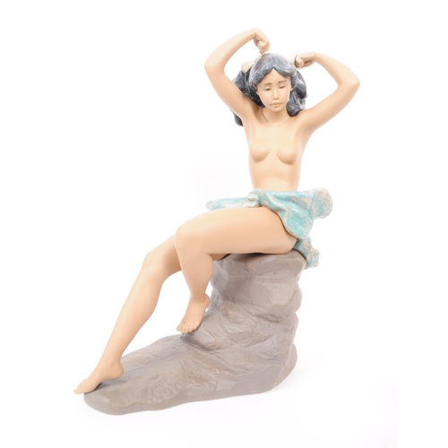 87 - Lladro - Nao - Two late 20th century porcelain nude lady figurines. Comprised of a large 1992 figure... 