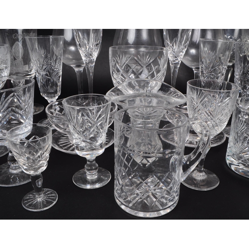 16 - A collection of 20th century crystal cut and acid etched glassware, including examples by Thomas Web... 