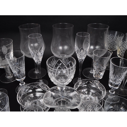 16 - A collection of 20th century crystal cut and acid etched glassware, including examples by Thomas Web... 