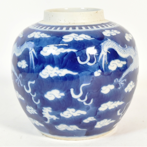 21 - A 19th century Chinese blue and white porcelain ginger jar, decorated with two dragons flying amongs... 