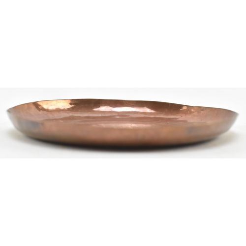 102 - Newlyn Copper - a Newlyn Cornish embossed copper trinket dish plate. The dish of circular form and r... 