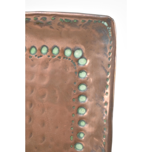 116 - John Pearson (British 1858-1930) - An Arts and Crafts Cornish embossed copper twin handled tray. The... 