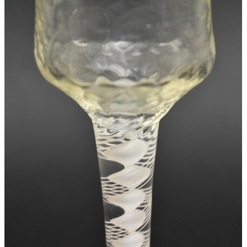 130 - A mid 18th century George II circa 1765 wine glass. The wine glass with textured ogee bowl over doub... 