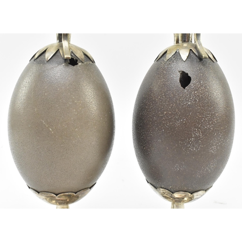 131 - A pair of early 20th century Australian vases, each formed from central emu egg. Each vase featuring... 