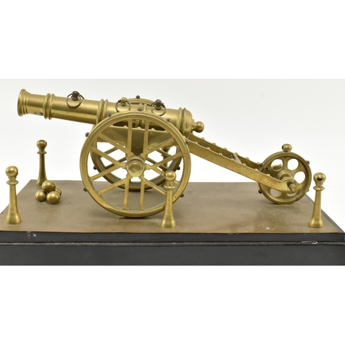 139 - A 19th century Victorian brass model of a cannon. The artillery cannon figure complete with four can... 